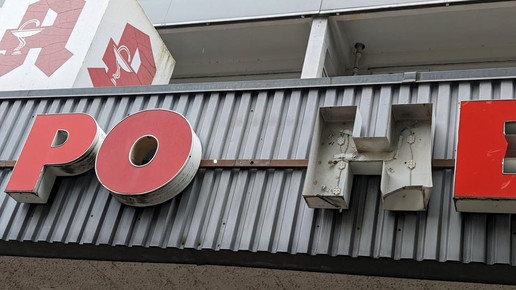 Leuchtbuchstaben über verlassener Apotheke