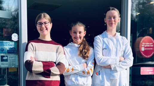 Drei junge Frauen vor der Apotheke.