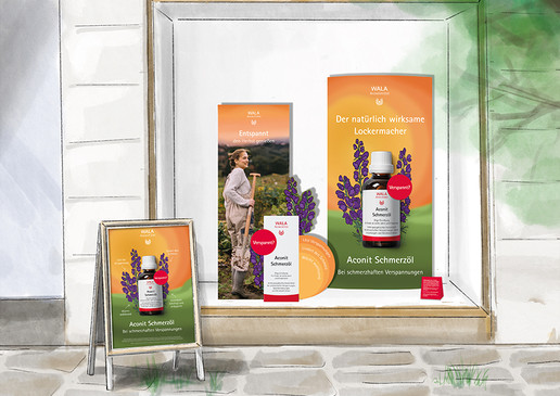 Schaufensterdekoration mit Werbematerialien für WALA Aconit Schmerzöl. Zu sehen sind Plakate, Aufsteller und eine Produktabbildung der Flasche vor orange-grünem Hintergrund mit Eisenhut-Illustrationen. Ein Plakat zeigt eine Frau mit Spaten auf einer Wiese.