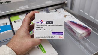 Mounjaro-Testkauf: Apotheker zeigt Mängel Symbolbild: Apotheker nimmt eine Packung Mounjaro aus dem Schrank.