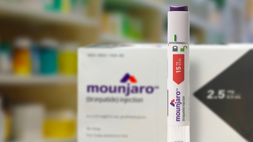 Foto: Stehender Mounjaro-15-mg-Pen, Packung im Hintergrund