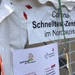 Zelt mit Poster „Corona-Schnelltest-Zentrum im Nordbezirk“.