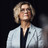 Das Foto zeigt Anne-Kathrin Klemm, Vorständin des BKK Dachverbandes. Sie steht im grauen Blazer vor einem schwarzen Hintergrund.