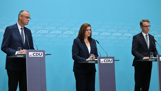 Friedrich Merz, Franziska Hoppermann und Carsten Linnemann am Rednerpult bei einem Statement