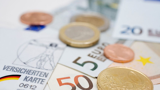 Symbolbild: Geldscheine, Münzen und Gesundheitskarte 