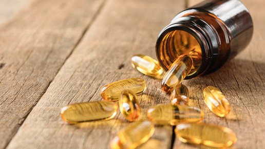 Ein Glas mit Kapseln liegt ausgeschüttet auf dem Tisch.